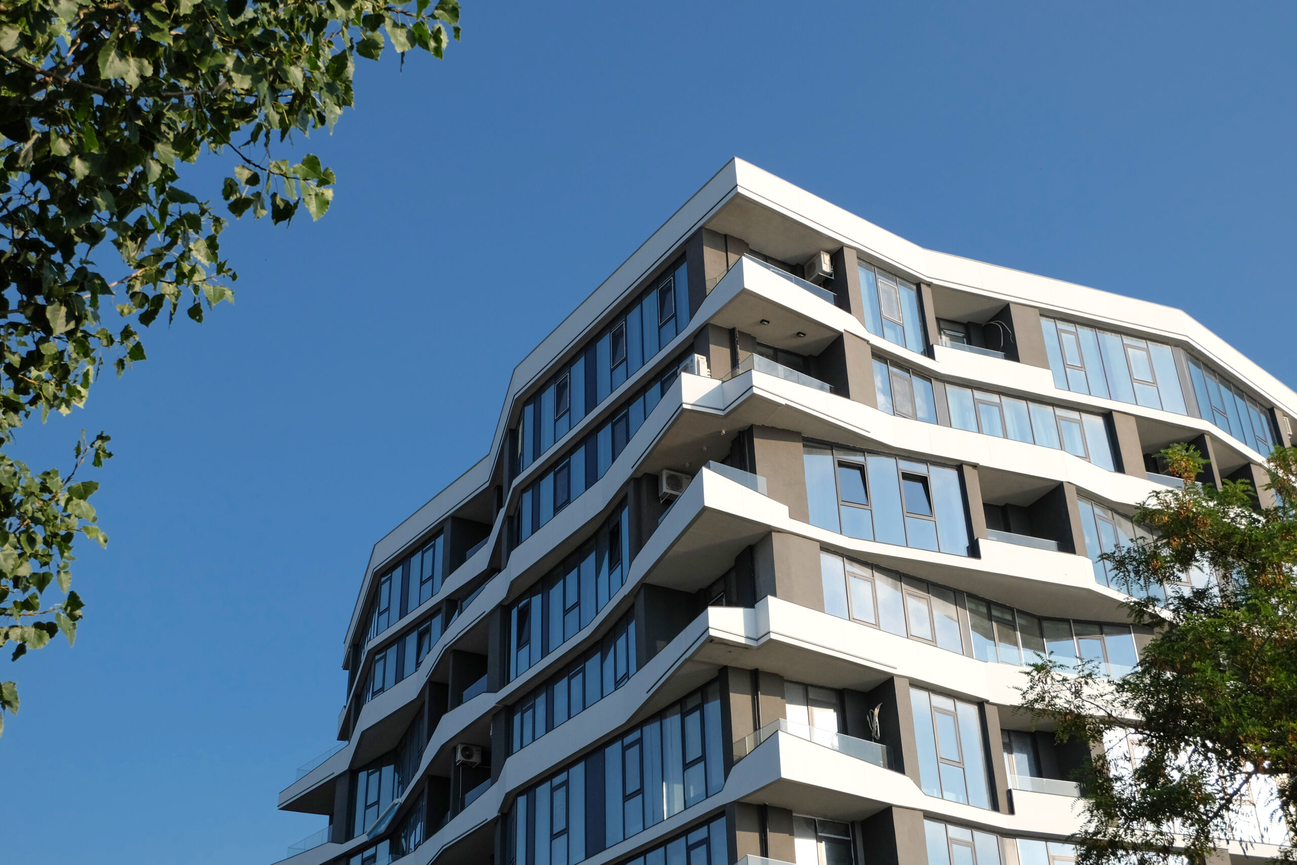fragment modern building against blue sky real estate scaled